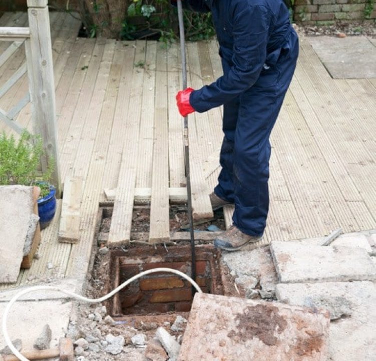 Débouchage de canalisation en passant par un regard extérieur à l'aide d'un furet manuel droit